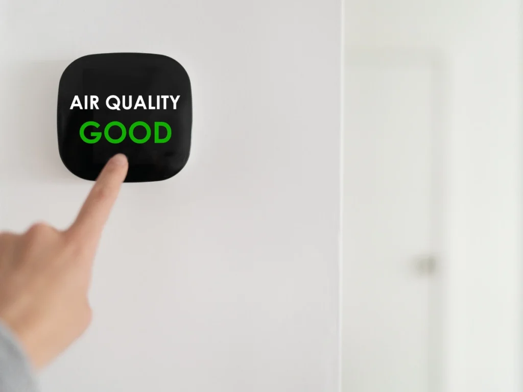 A wall-mounted control panel displaying "Air Quality Good," showing the benefits of upgrading your air conditioning system for better indoor air quality.